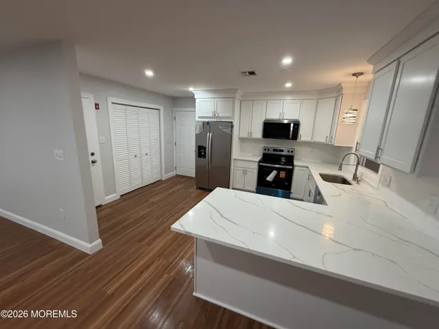 a kitchen with a sink stove and refrigerator