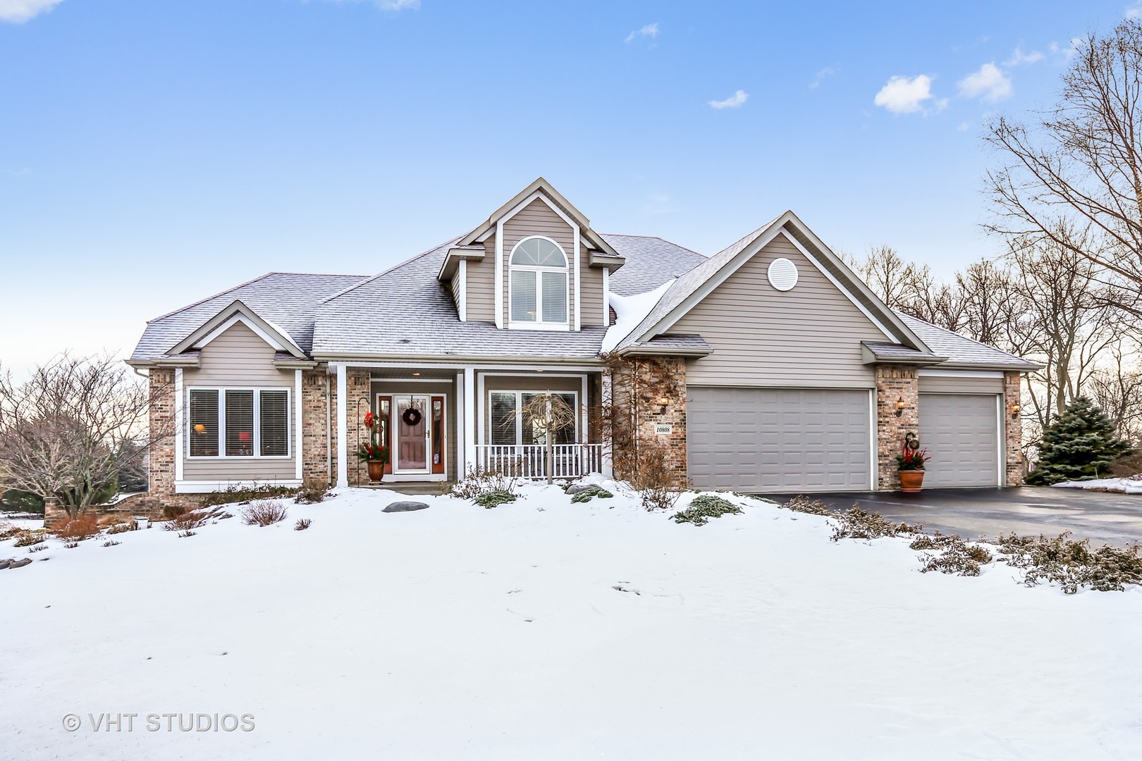 10808 West Riviera Drive Spring Grove, IL 60081 - Photo 1 of 16 a front view of a house with a yard