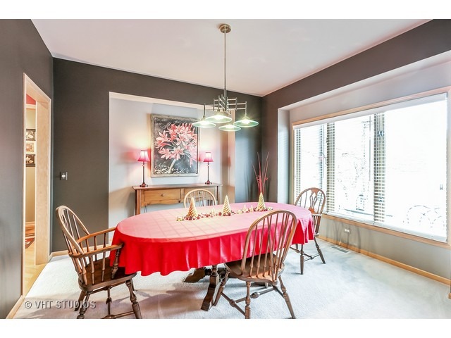 10808 West Riviera Drive Spring Grove, IL 60081 - Photo 4 of 16 a dining room with furniture a chandelier and window