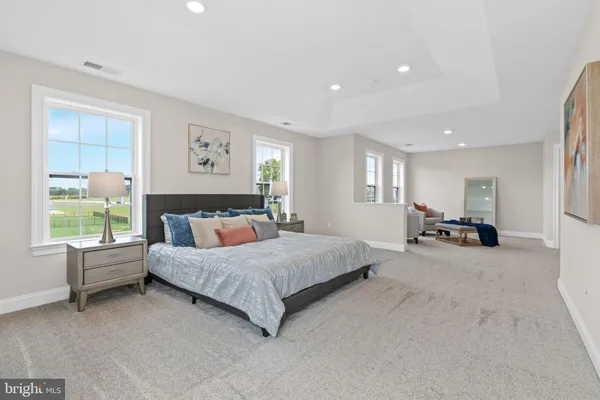 a spacious bedroom with a bed and glass window