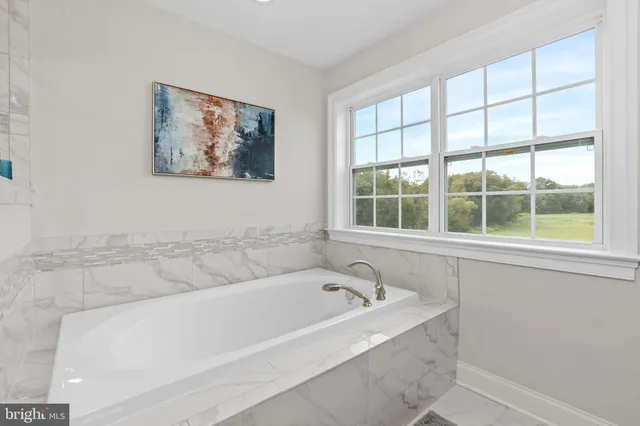 a white bath tub sitting next to a window