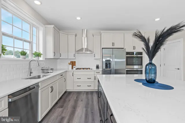 a kitchen with granite countertop a sink and cabinets