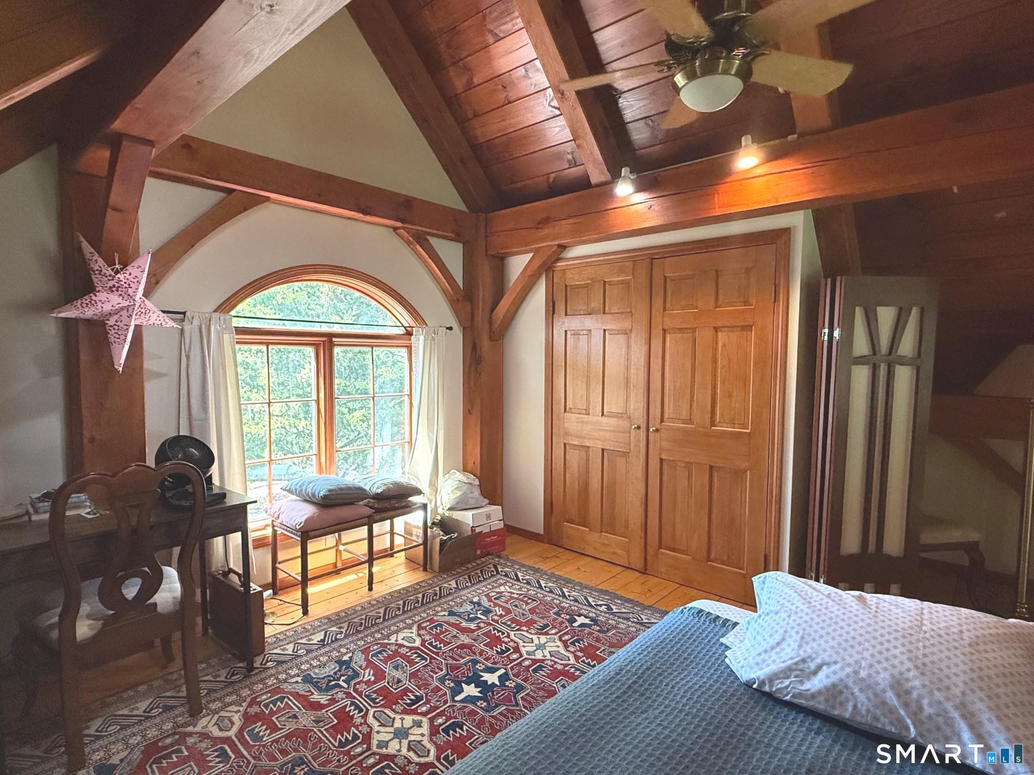 8 Ivy Road Stonington, CT 06355 - Photo 24 of 30 a bedroom with furniture and a large window
