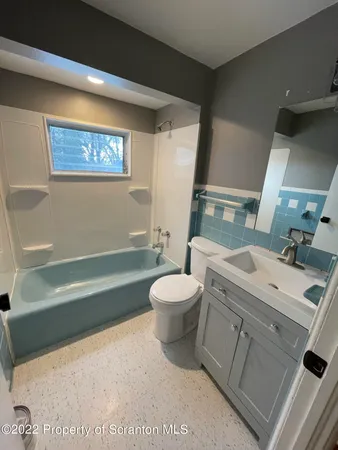 a bathroom with a sink a toilet and a bathtub