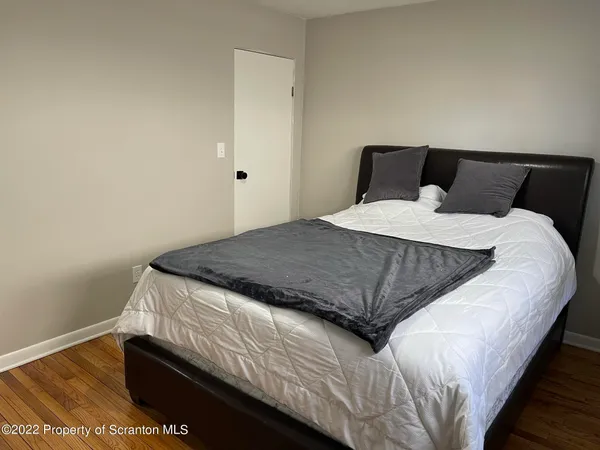 a kitchen with a checkered floor and white cabinets