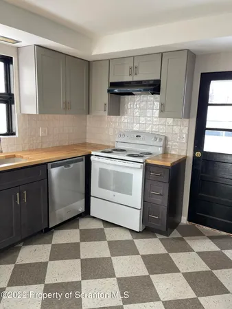a kitchen with stainless steel appliances and cabinets