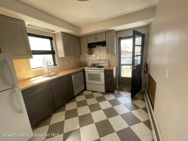 a kitchen with a stove a sink and a refrigerator