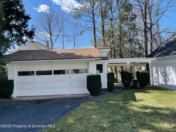 a view of a house with a yard and sitting area
