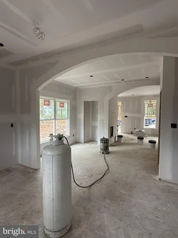 a living room with furniture a flat screen tv and a window