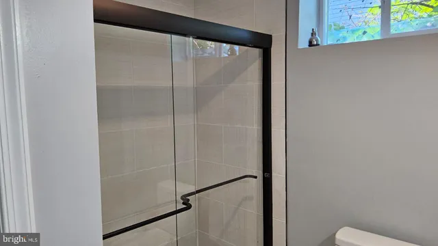 an empty room with wooden floor and closet