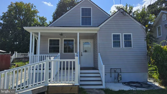a view of a house with wooden deck and a yard