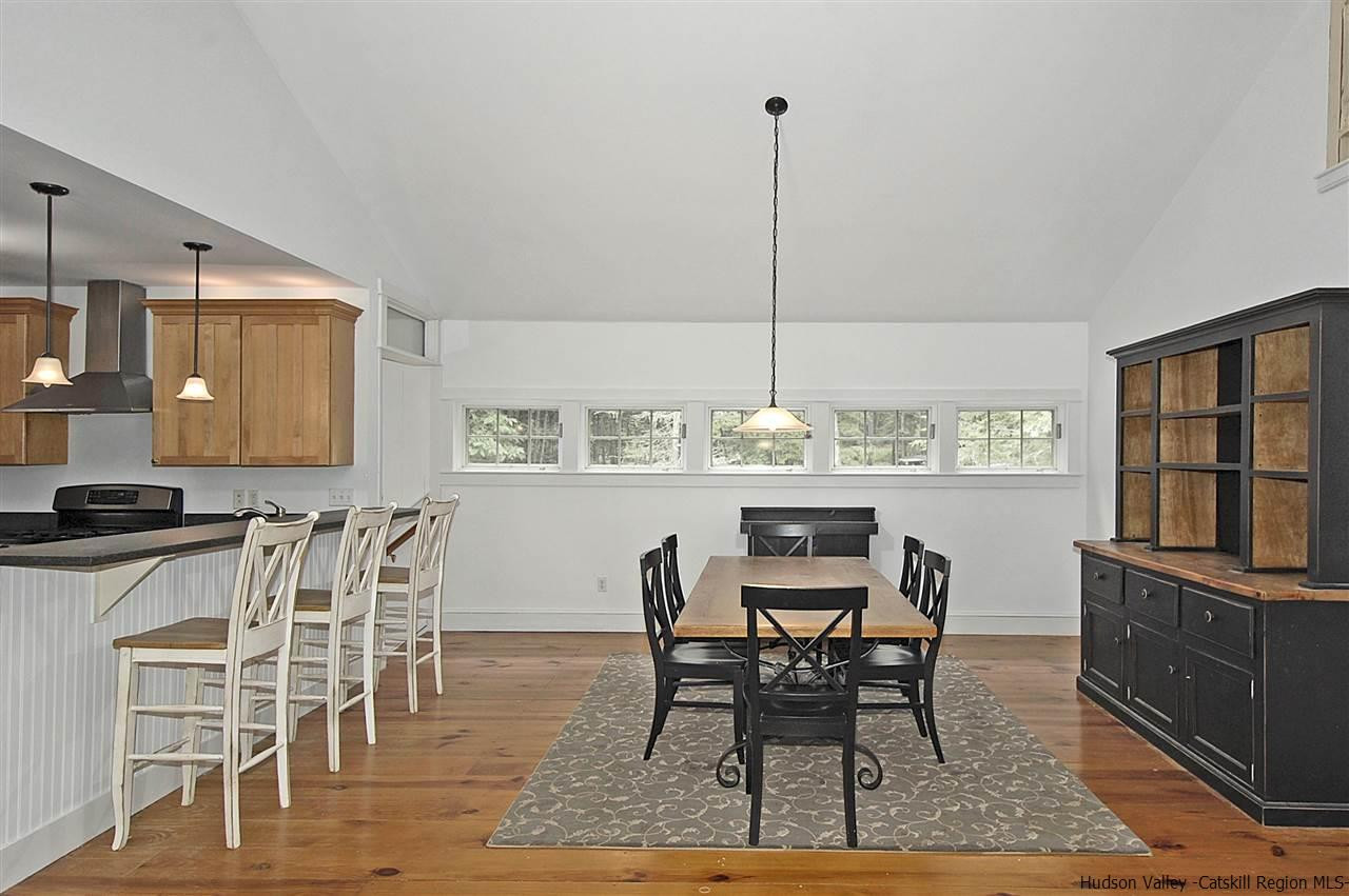 522 Buck Road Stone Ridge, NY 12484 - Photo 12 of 30 a view of a a dining room with furniture window and wooden floor
