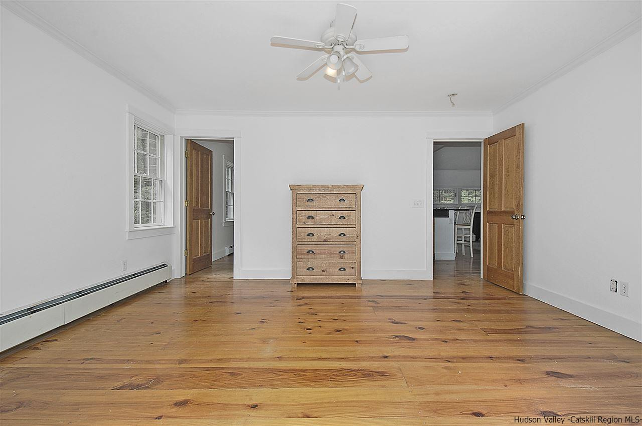 522 Buck Road Stone Ridge, NY 12484 - Photo 20 of 30 a view of an empty room with window and wooden floor