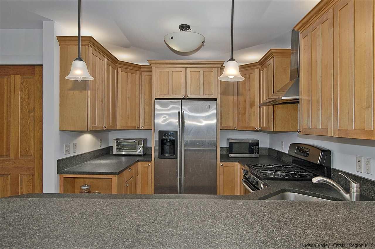 522 Buck Road Stone Ridge, NY 12484 - Photo 9 of 30 a kitchen with stainless steel appliances granite countertop a sink a stove and a refrigerator
