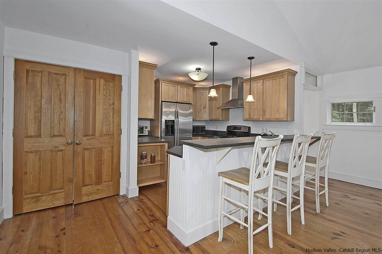 522 Buck Road Stone Ridge, NY 12484 - Photo 10 of 30 a kitchen with a refrigerator a sink and wooden floor
