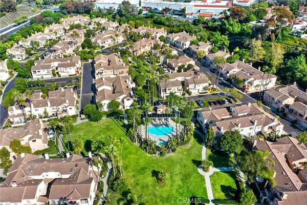 an aerial view of residential houses with trees