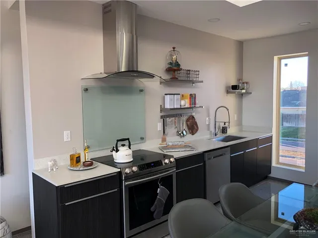 a kitchen with a sink cabinets and appliances