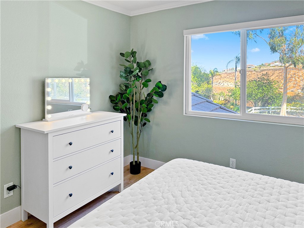 16955 Lake Knoll Parkway Riverside, CA 92503 - Photo 23 of 42 a bedroom with a bed and a potted plant