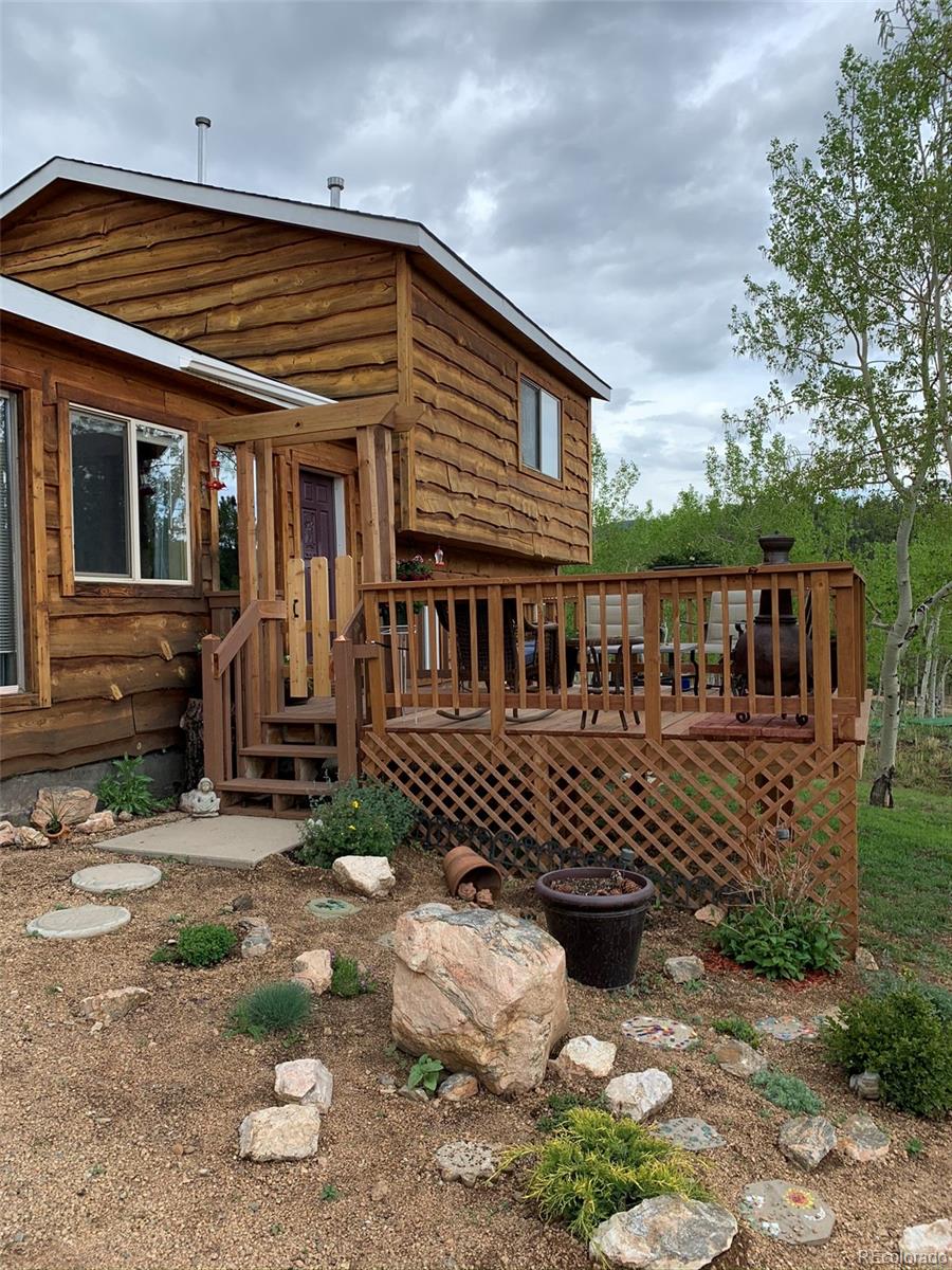 161 Saddlestring Road Bailey, CO 80421 - Photo 2 of 32 a front view of a house with a yard