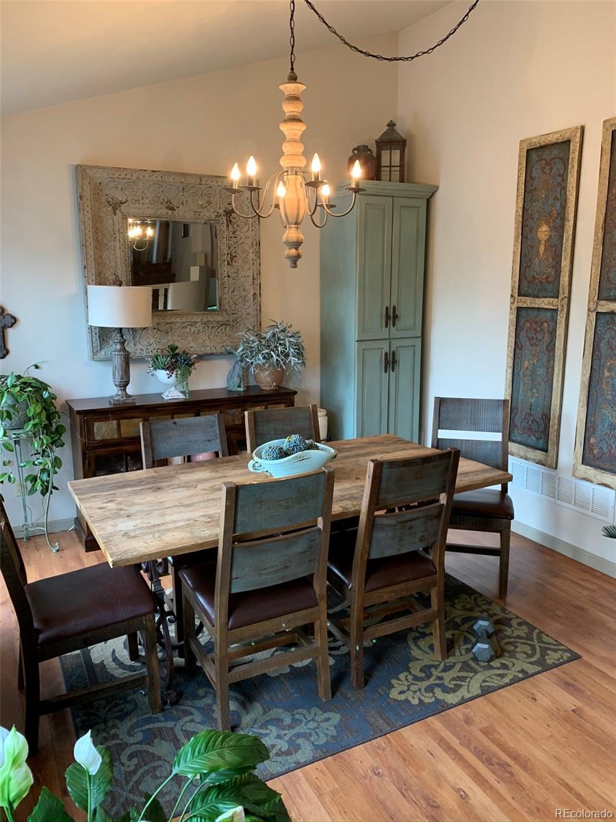 161 Saddlestring Road Bailey, CO 80421 - Photo 3 of 32 a view of a dining room with furniture and a chandelier