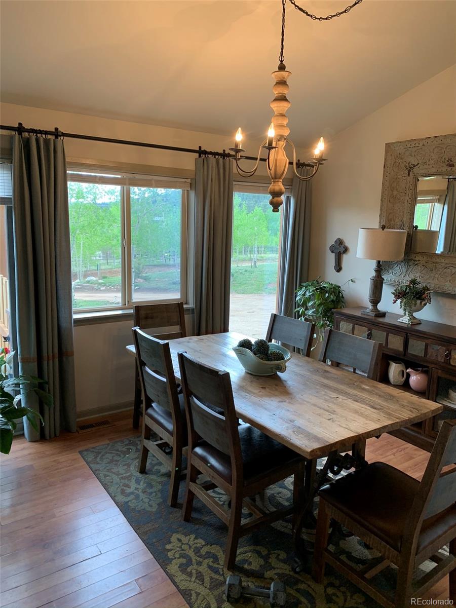 161 Saddlestring Road Bailey, CO 80421 - Photo 4 of 32 a view of a dining room with furniture window and wooden floor