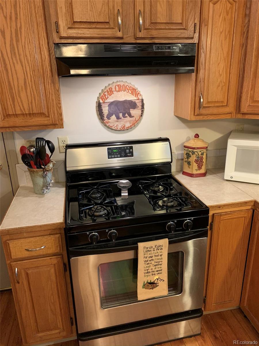 161 Saddlestring Road Bailey, CO 80421 - Photo 6 of 32 a stove top oven sitting inside of a kitchen