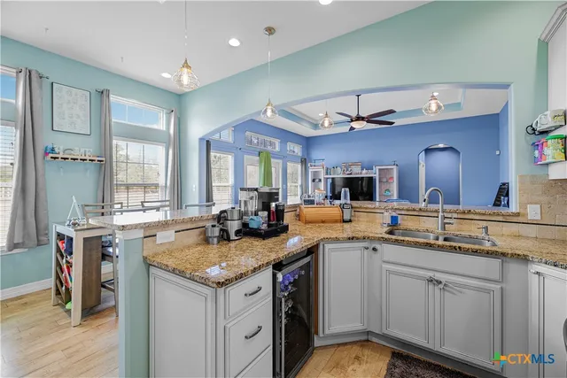 a kitchen with a sink stove and cabinets