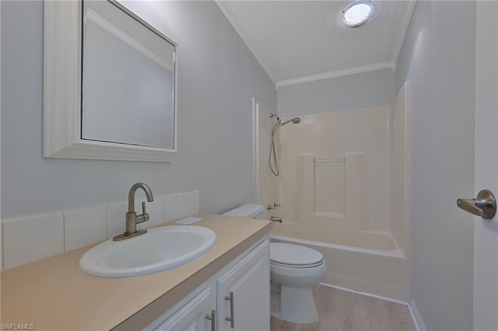 276 Grosbeak Lane, Unit 276 Naples, FL 34114 - Photo 11 of 13 a bathroom with a sink toilet and shower
