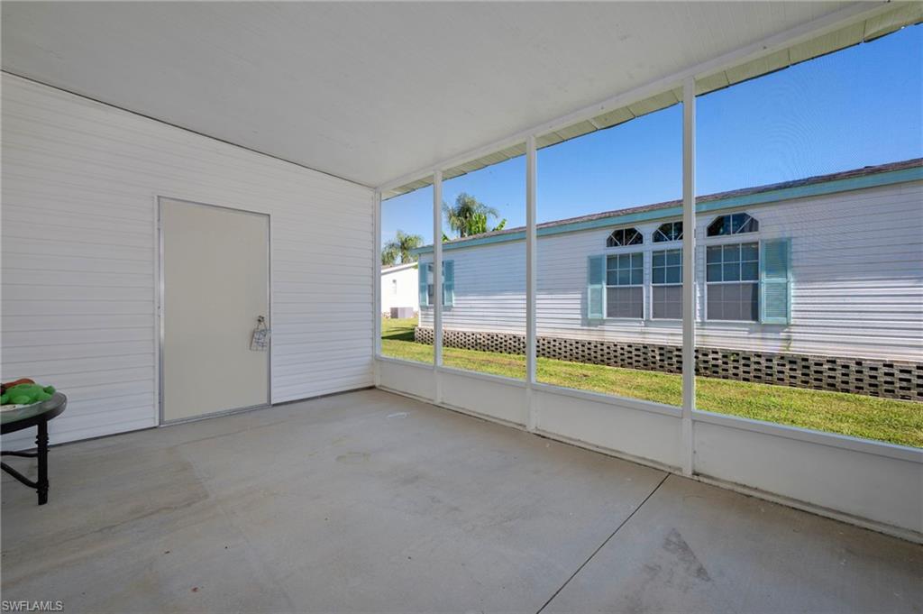 276 Grosbeak Lane, Unit 276 Naples, FL 34114 - Photo 13 of 13 a view of an empty room with a fireplace and a window