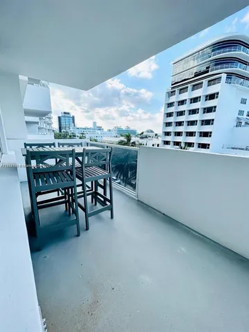 a view of dinning table and chairs in the balcony