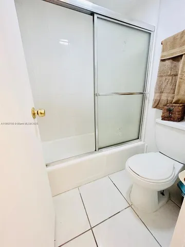a bathroom with a shower and a toilet