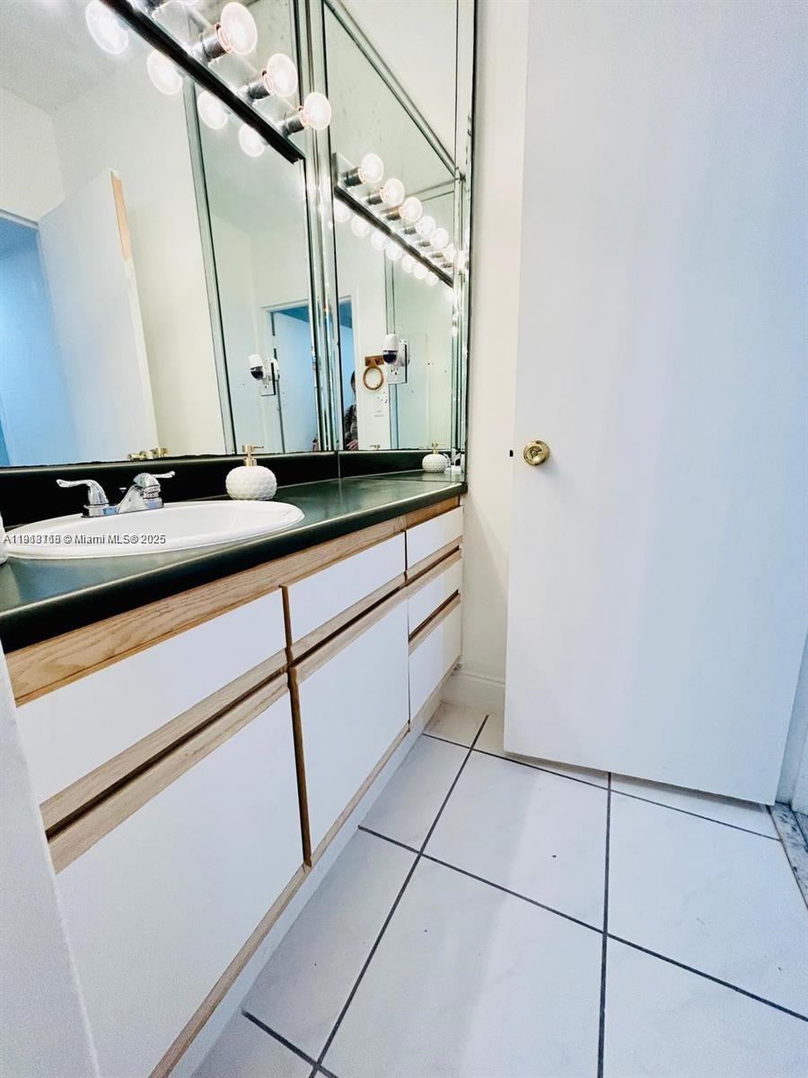 100 Lincoln Road, Unit 535 Miami Beach, FL 33139 - Photo 9 of 12 a bathroom with a sink and a mirror