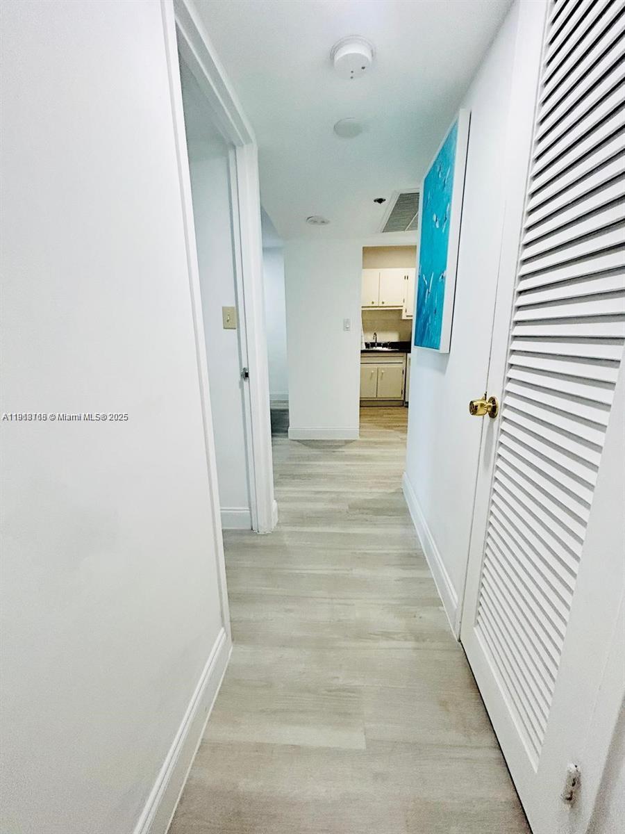 100 Lincoln Road, Unit 535 Miami Beach, FL 33139 - Photo 10 of 12 a view of a hallway with wooden floor and staircase