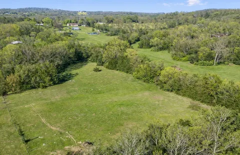 a view of a big yard with lots of green space and mountain view