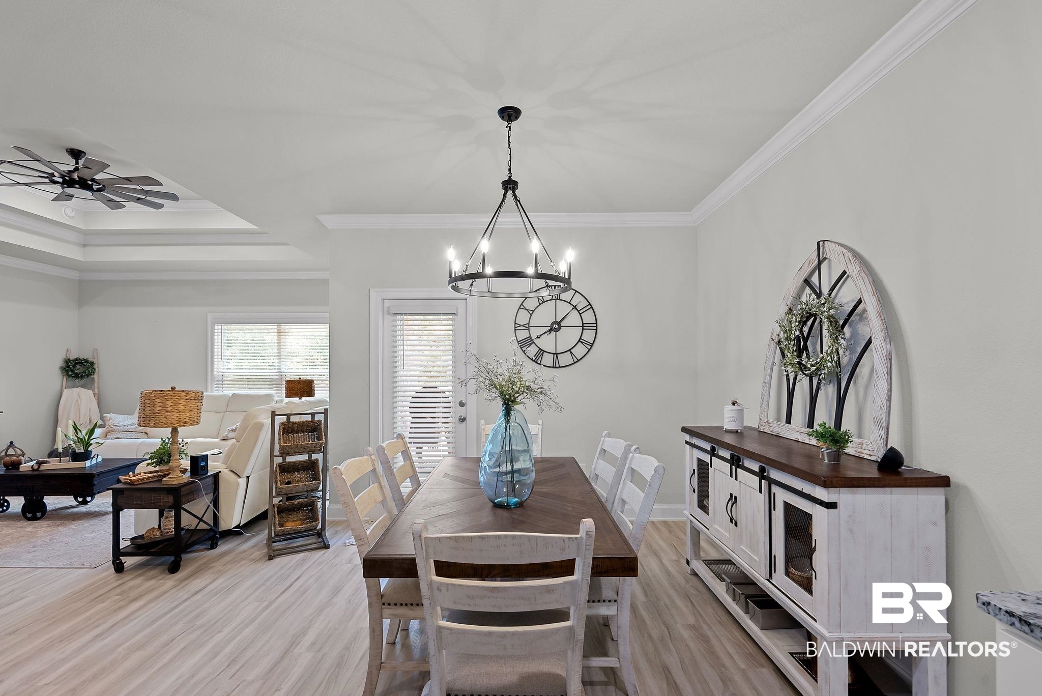 13966 Antler Hl Road Daphne, AL 36527 - Photo 10 of 44 Open-concept dining area featuring wood-finish flooring, a contemporary chandelier, and crown molding