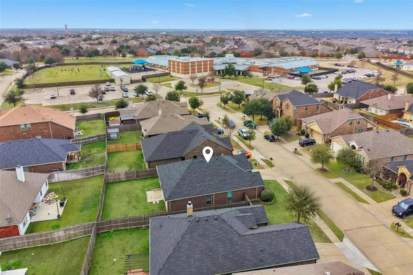 an aerial view of residential houses with outdoor space and swimming pool