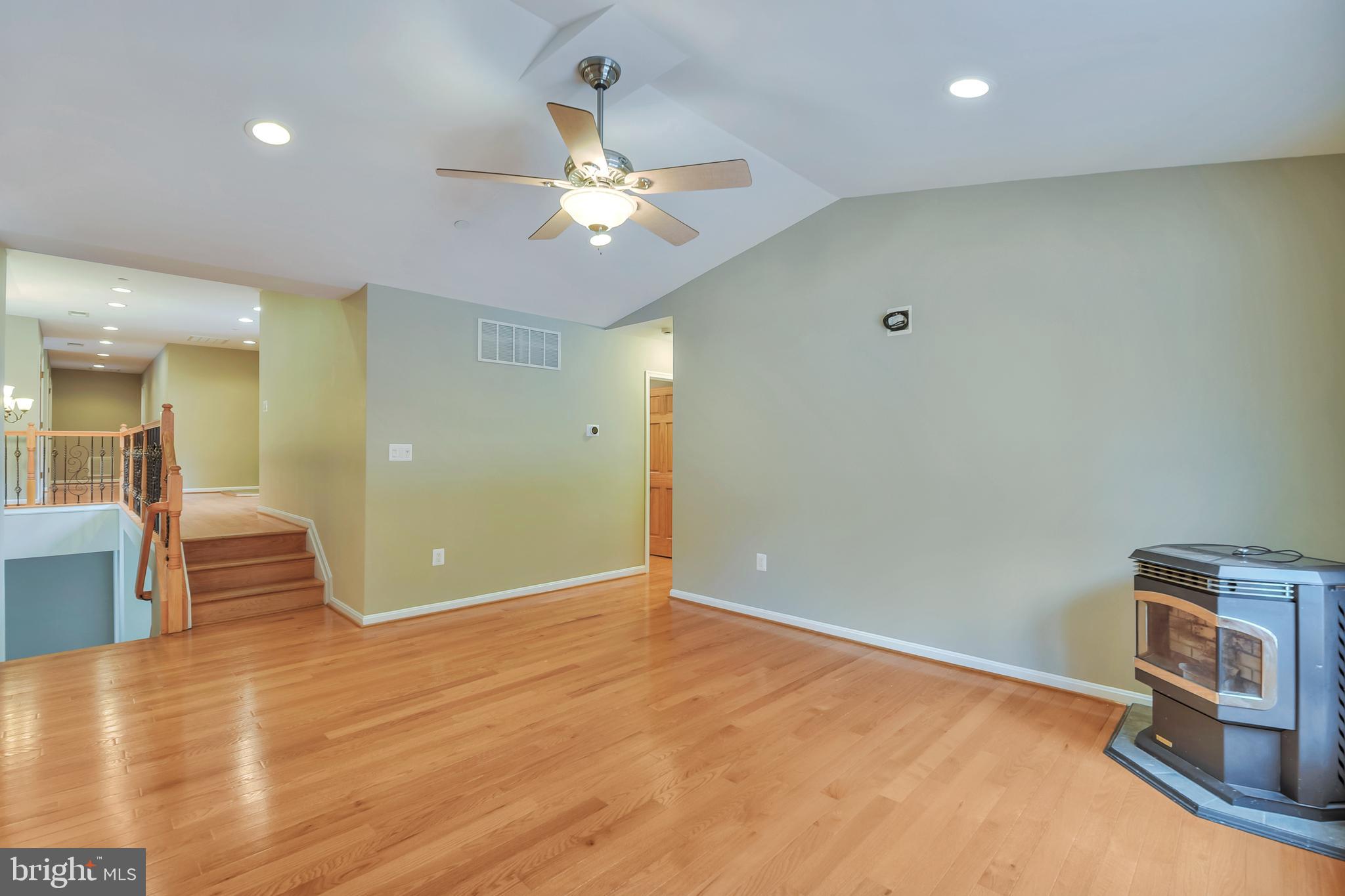 7715 Paradise Beach Road Pasadena, MD 21122 - Photo 22 of 66 an empty room with wooden floor and way to kitchen