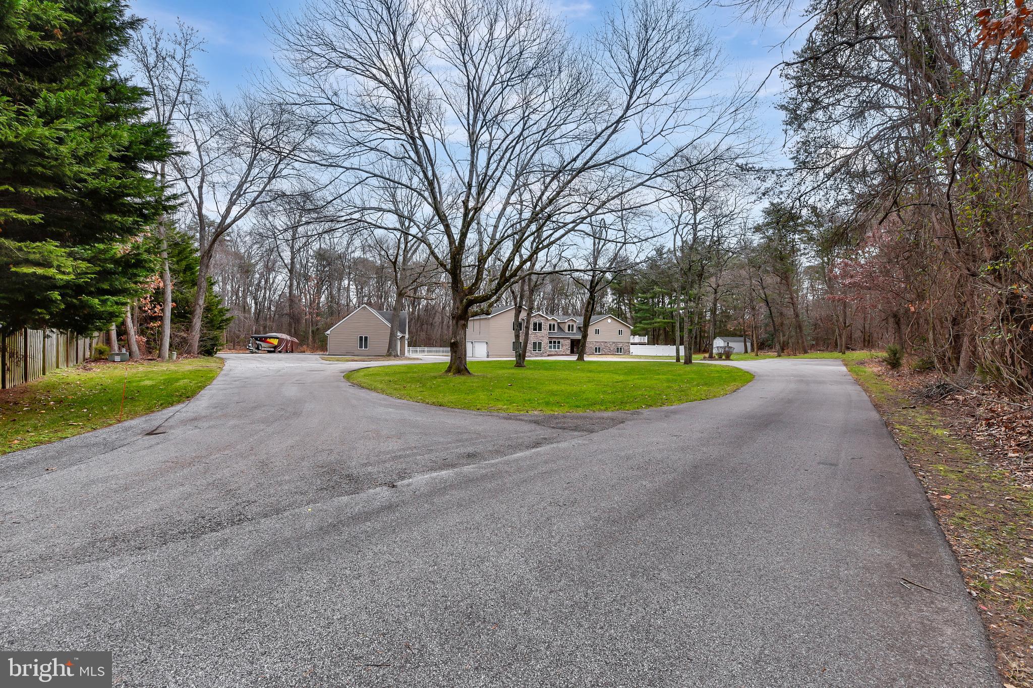 7715 Paradise Beach Road Pasadena, MD 21122 - Photo 3 of 62 a view of a house with a big yard and large trees