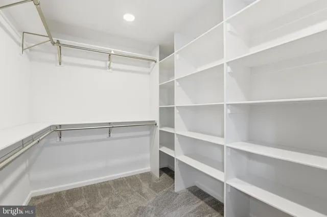 an empty room with closet and windows