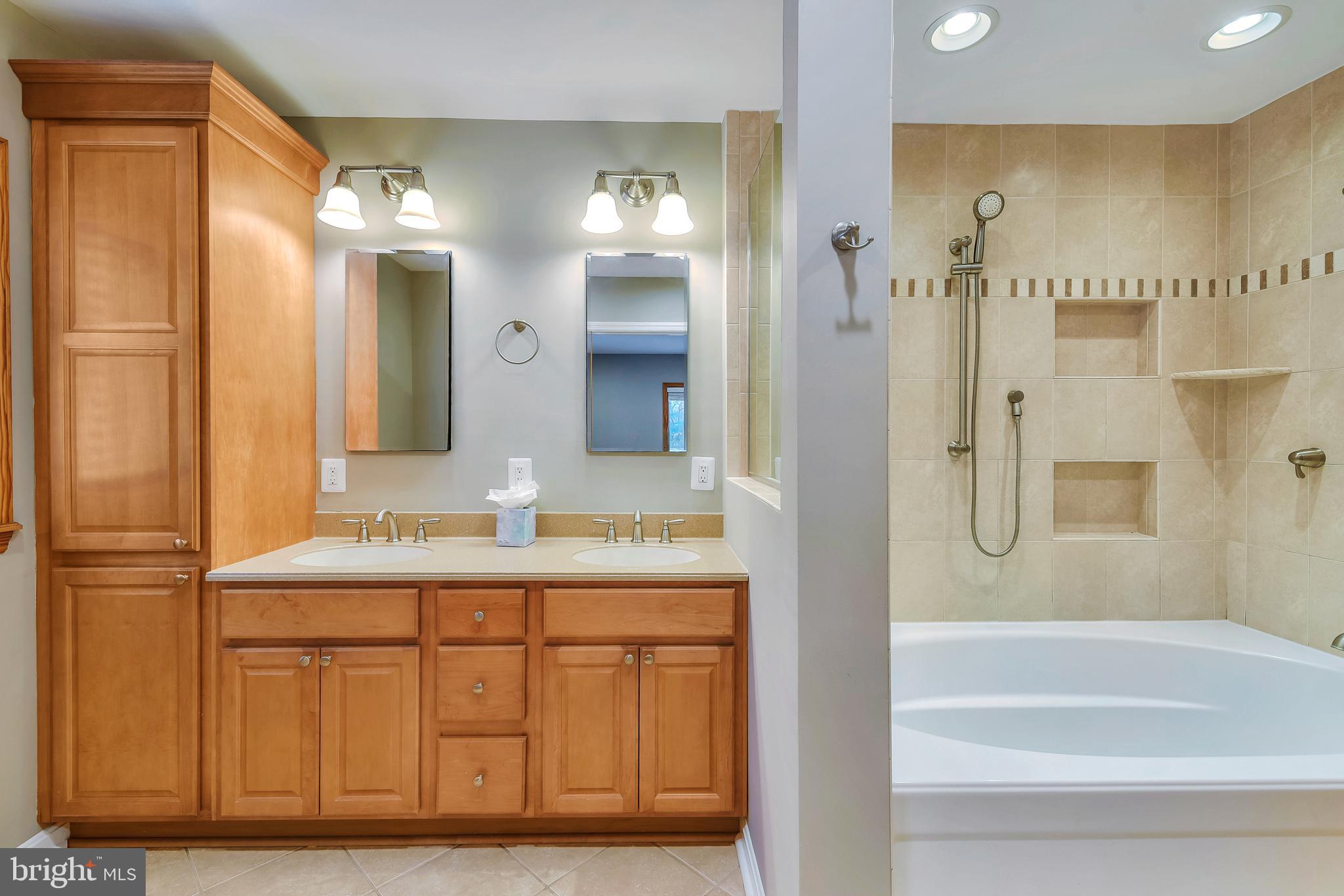 7715 Paradise Beach Road Pasadena, MD 21122 - Photo 36 of 62 a bathroom with a granite countertop sink a mirror a bathtub and shower