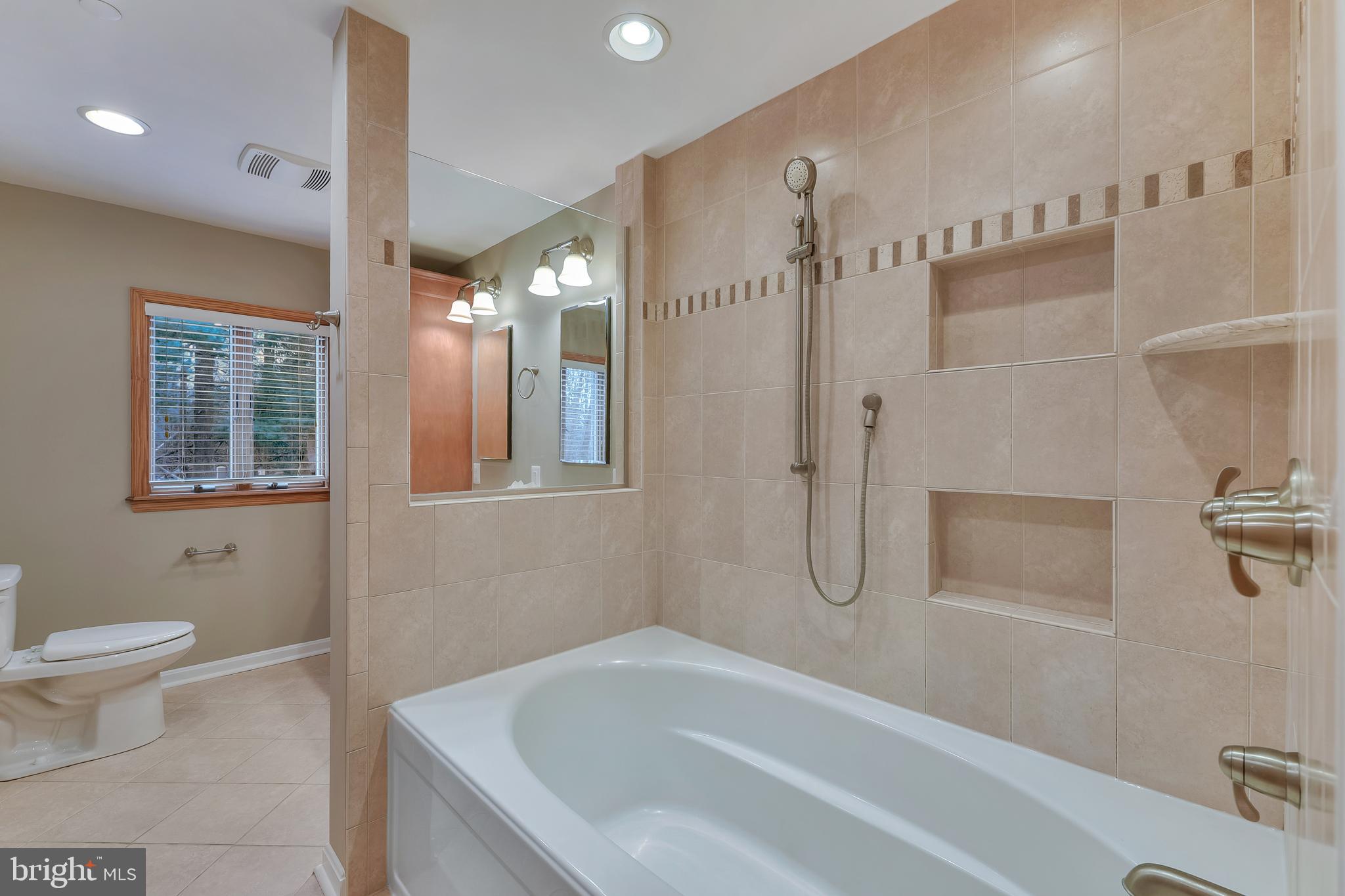 7715 Paradise Beach Road Pasadena, MD 21122 - Photo 37 of 62 a bathroom with a tub sink and toilet