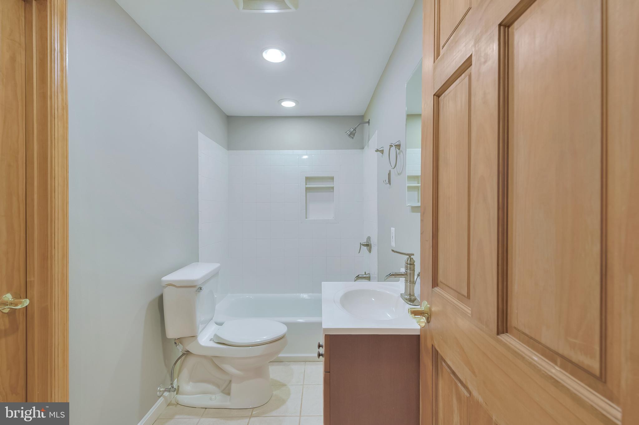 7715 Paradise Beach Road Pasadena, MD 21122 - Photo 45 of 66 a bathroom with a toilet a sink and a shower