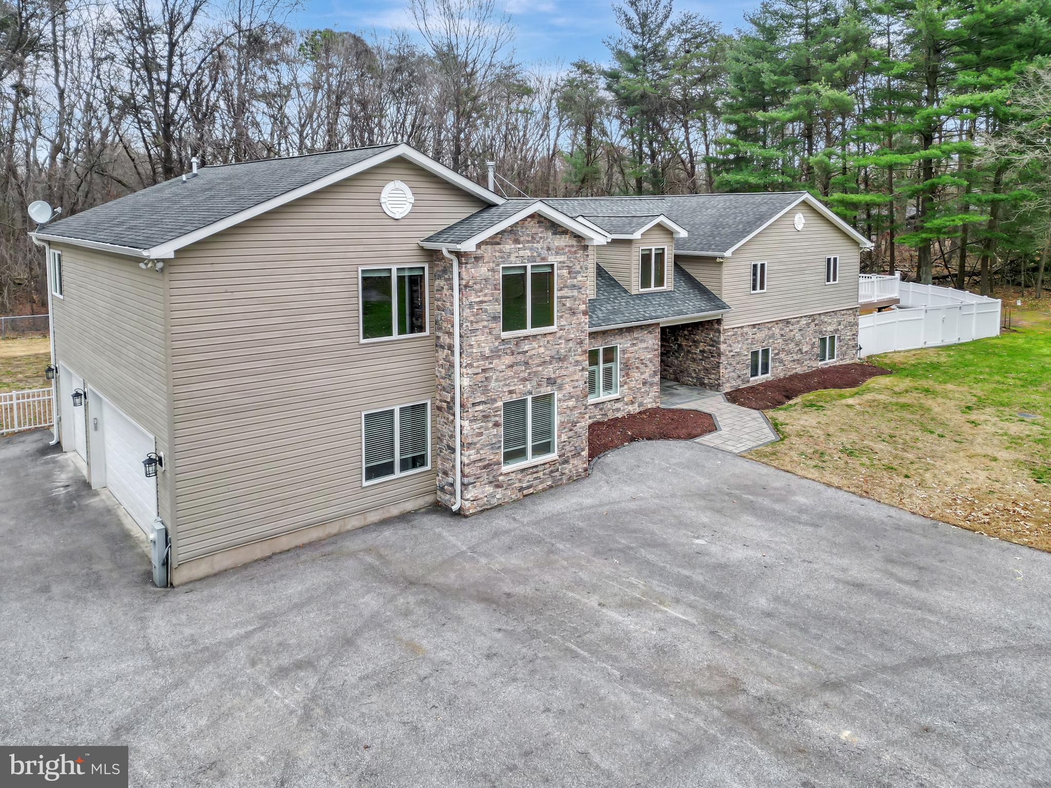 7715 Paradise Beach Road Pasadena, MD 21122 - Photo 47 of 62 a front view of a house with a yard and garage