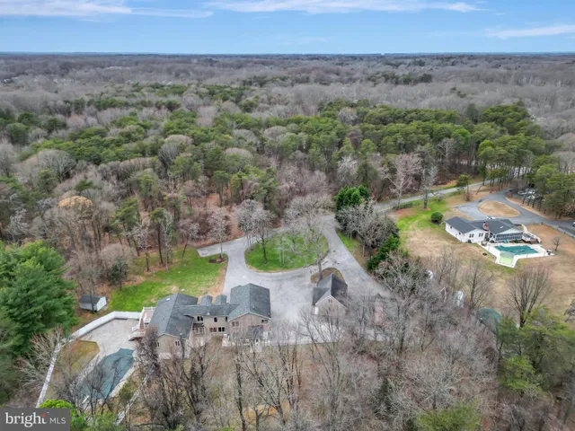 an aerial view of a house with a yard and trees