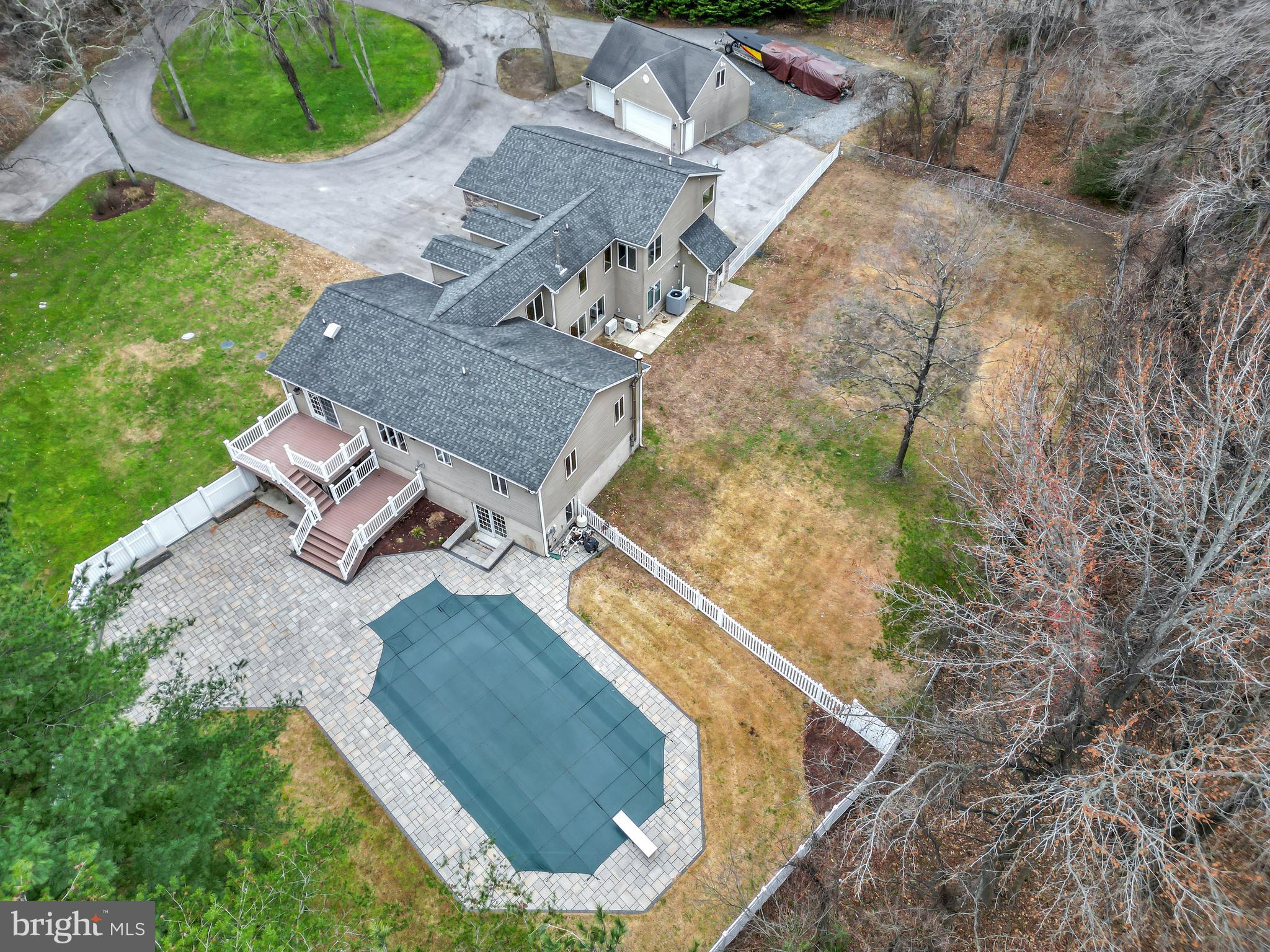 7715 Paradise Beach Road Pasadena, MD 21122 - Photo 6 of 62 an aerial view of a house with a yard and trees