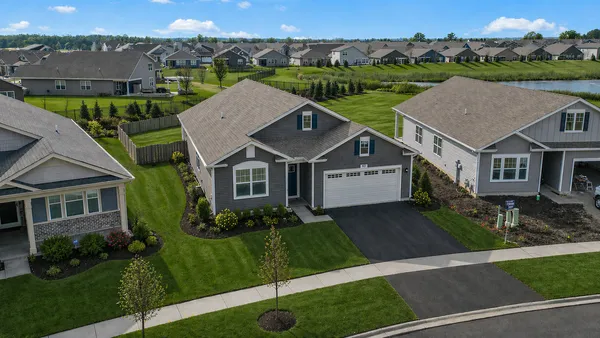 an aerial view of a house with a yard