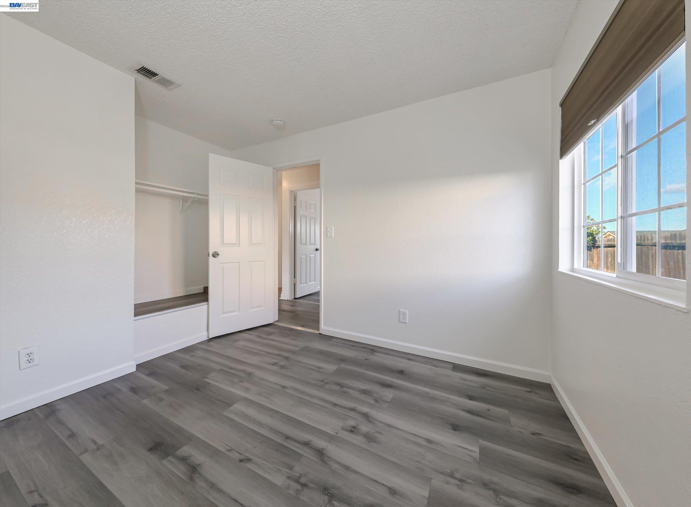 3432 Danielle Place Bay Point, CA 94565 - Photo 29 of 36 a view of an empty room with wooden floor and a window