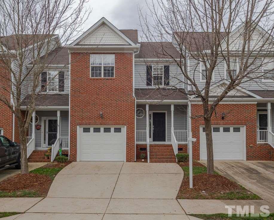 6025 Four Townes Lane Raleigh, NC 27616 - Photo 1 of 24 a front view of a house with a yard and garage
