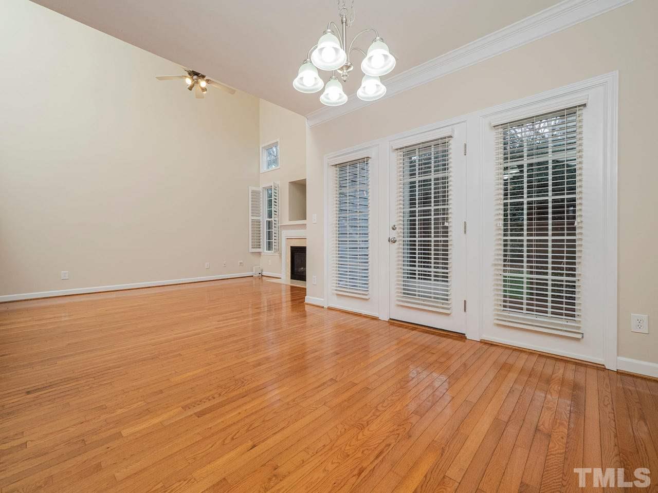 6025 Four Townes Lane Raleigh, NC 27616 - Photo 11 of 24 a view of an empty room with wooden floor and a window