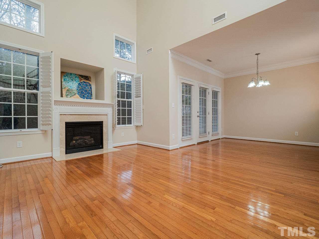 6025 Four Townes Lane Raleigh, NC 27616 - Photo 14 of 24 a view of an empty room with wooden floor fireplace and a window